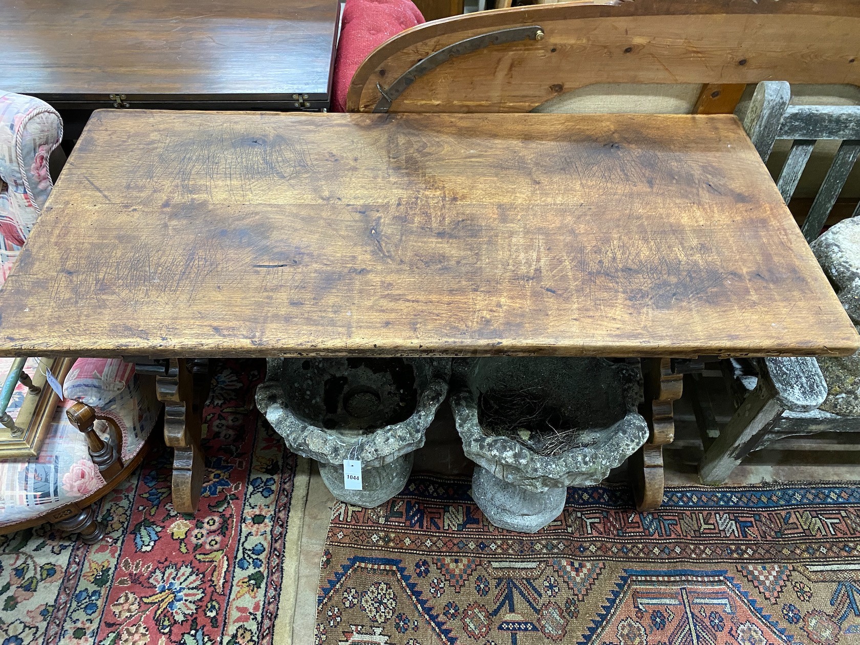 A Spanish walnut centre table, with wrought iron stretcher, width 151cm depth 69cm height 75cm
